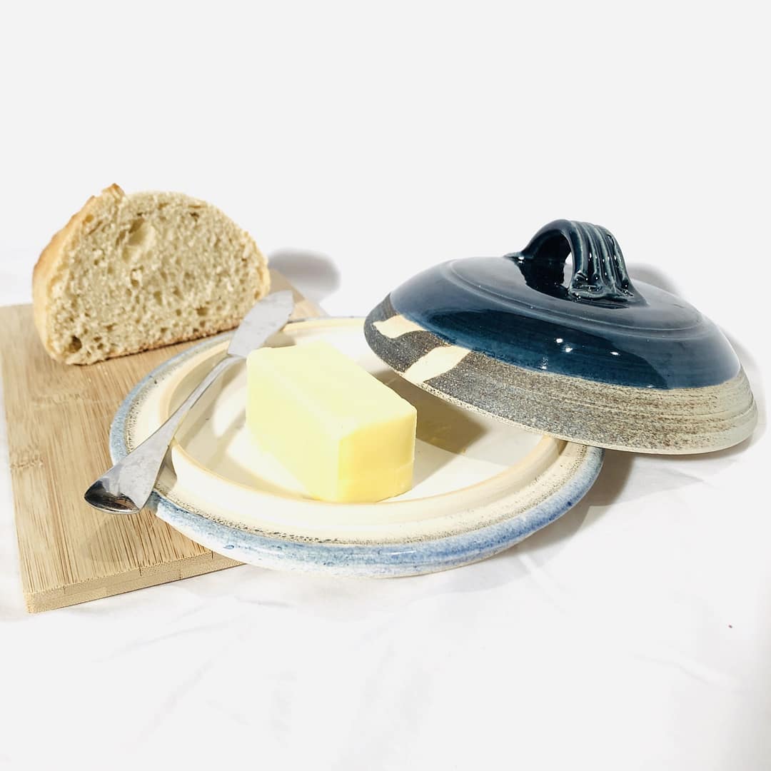 A butter dish with a dark blue lid