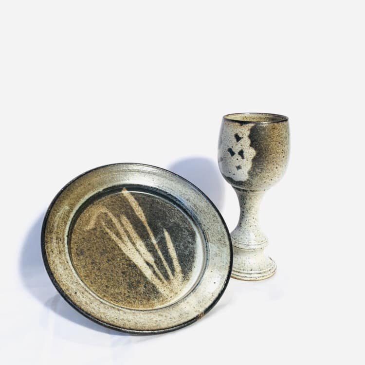 A communion paten and chalice with a neutral glaze