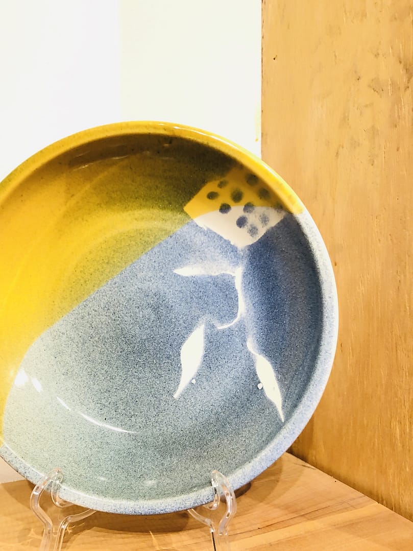 A bowl with blue and bright yellow glaze