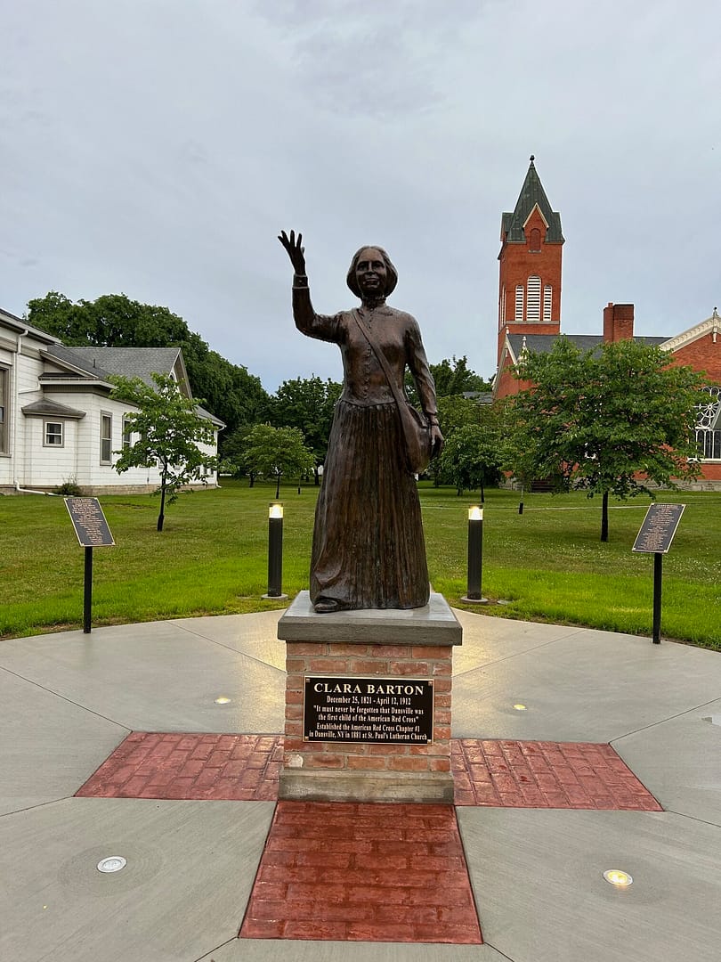 Final installed Clara Barton Sculpture on an outdoor masonry pedestal