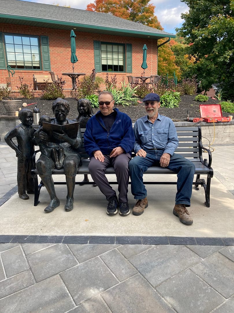 Donor and sculptor with installed sculpture at the Taylor Library.