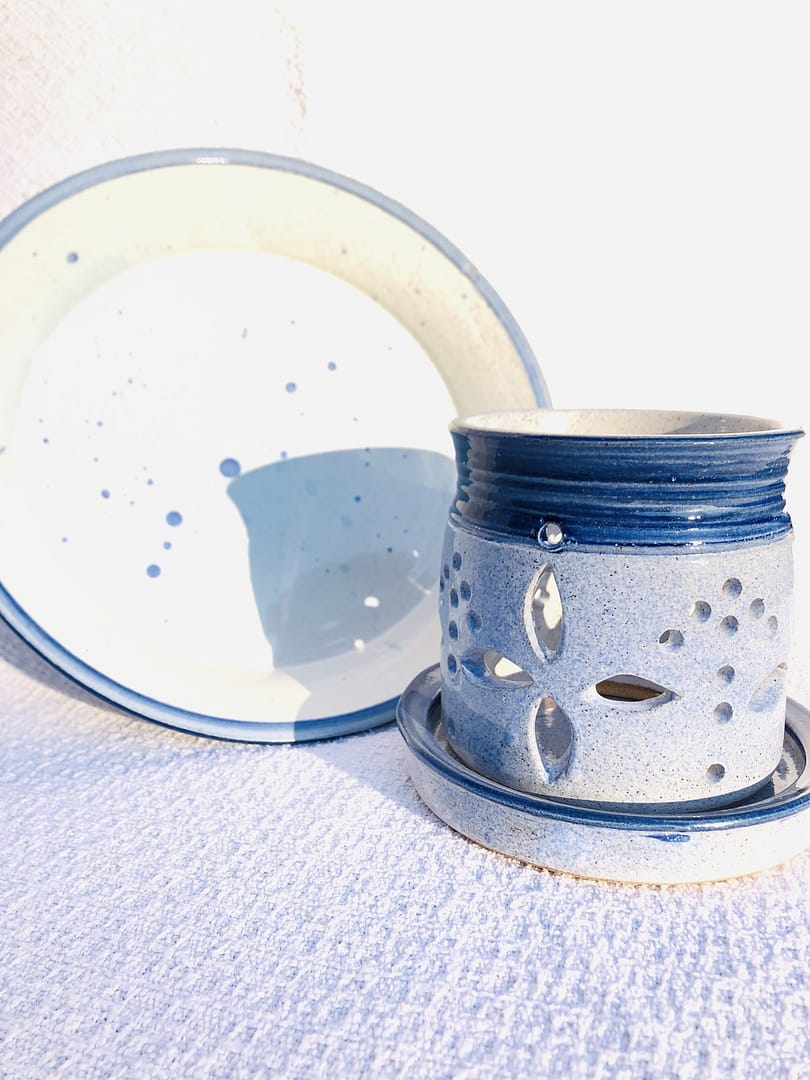 A large blue platter and matching candle holder or orchid pot